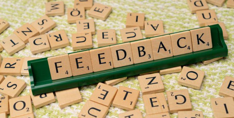 Customer Feedback - The word feedback is spelled out with scrabble tiles