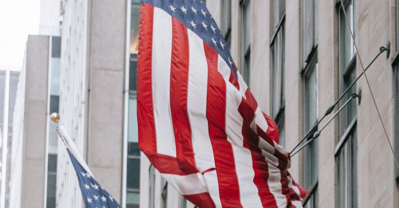 Perseverance - Row of American flags with stripe and star ornament on wall of embassy building in town